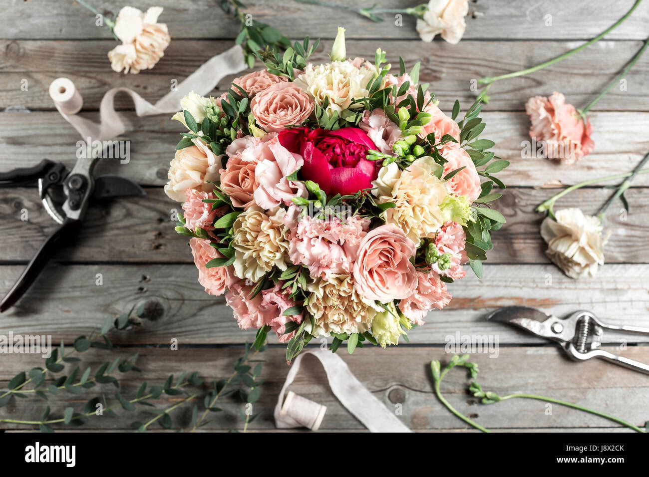 The florist desktop with working tools on gray old wooden background Stock Photo