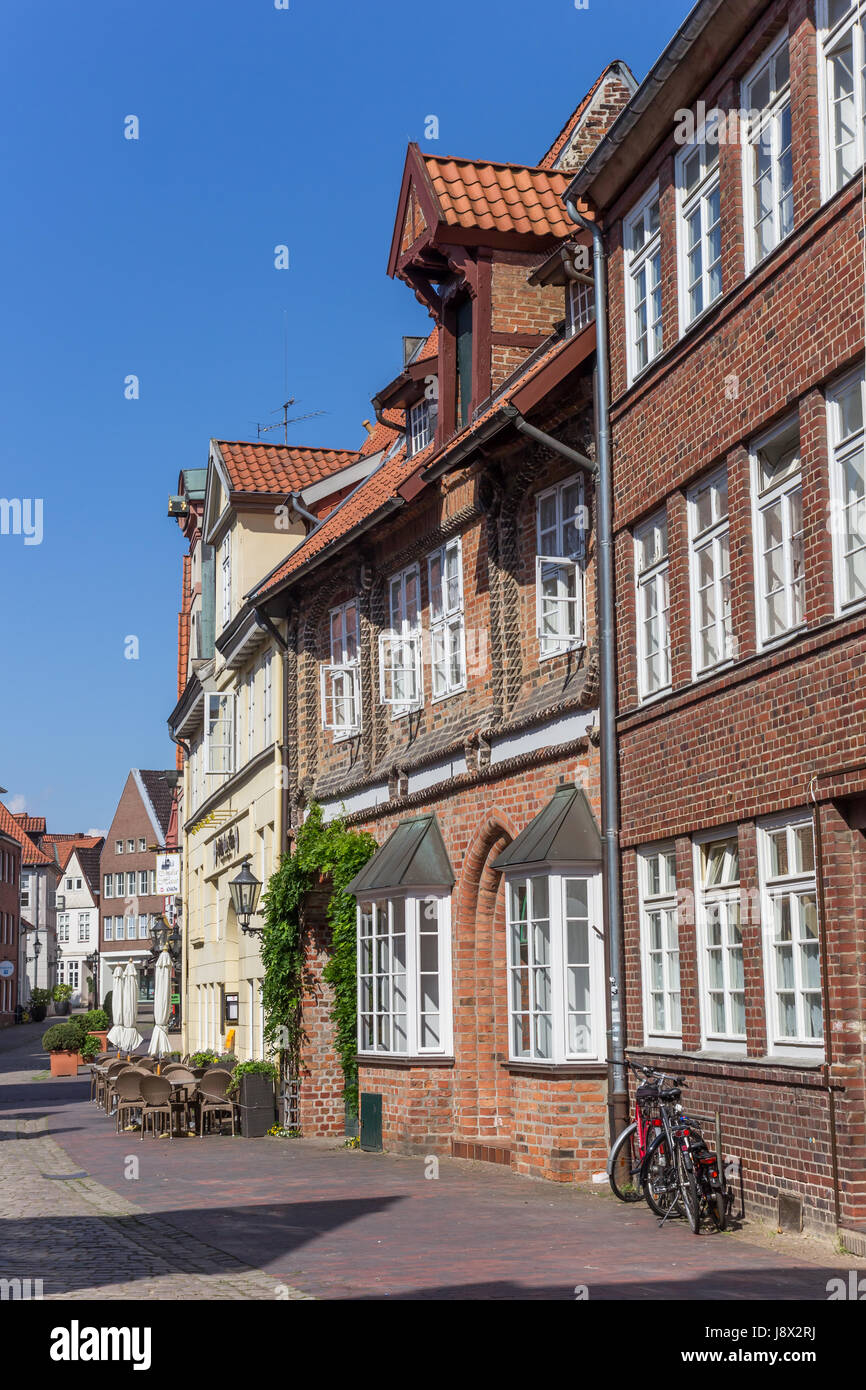 Street with historic houses and restaurant in Luneburg, Germany Stock Photo