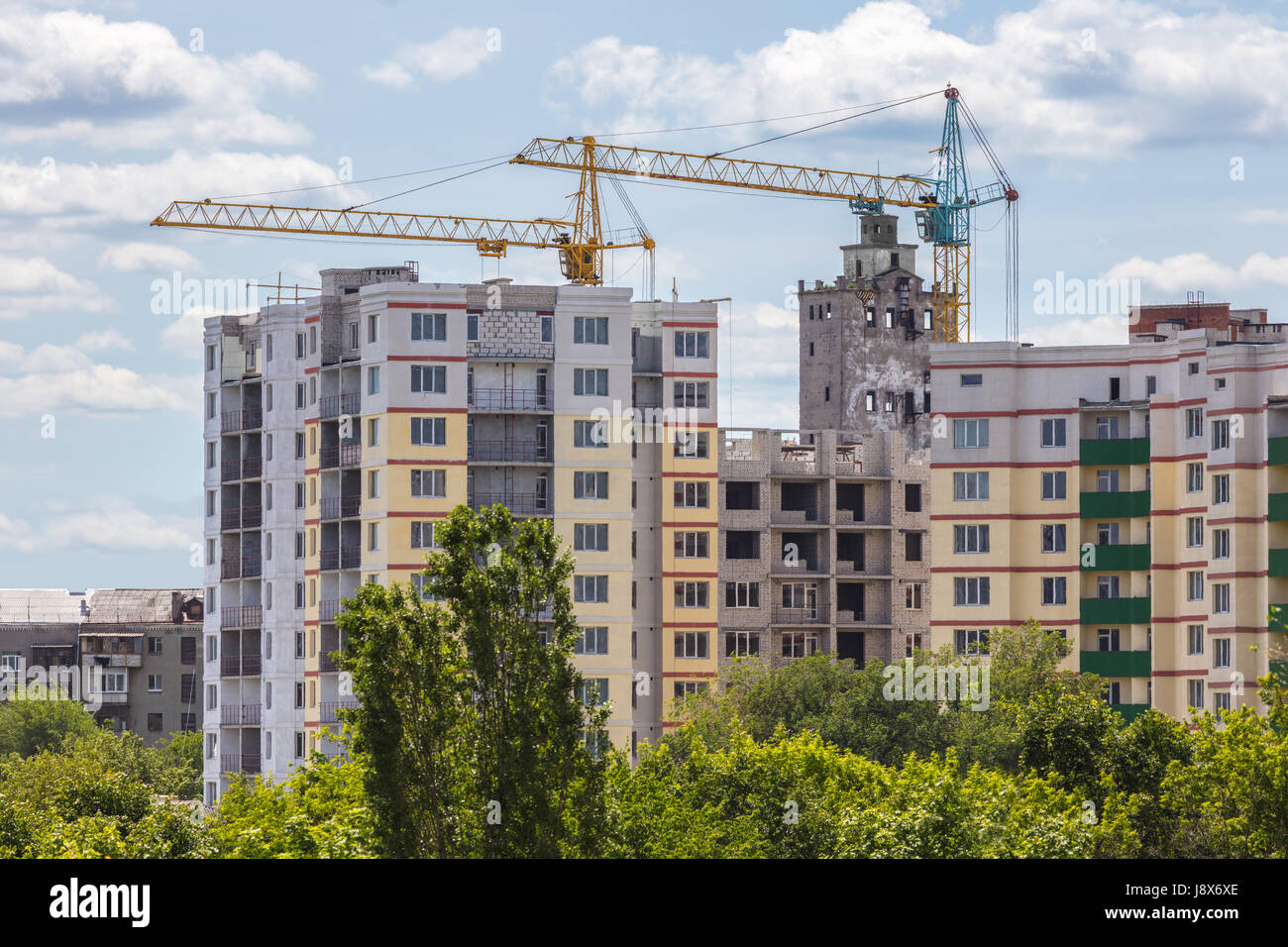 Industrial landscape, construction of high-rise buildings and cranes ...
