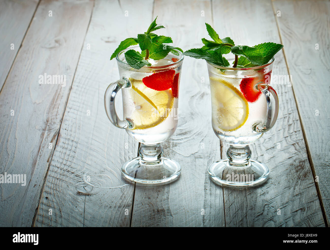 Fresh summer healthy drink with lemon and strawberries with ice. Stock Photo