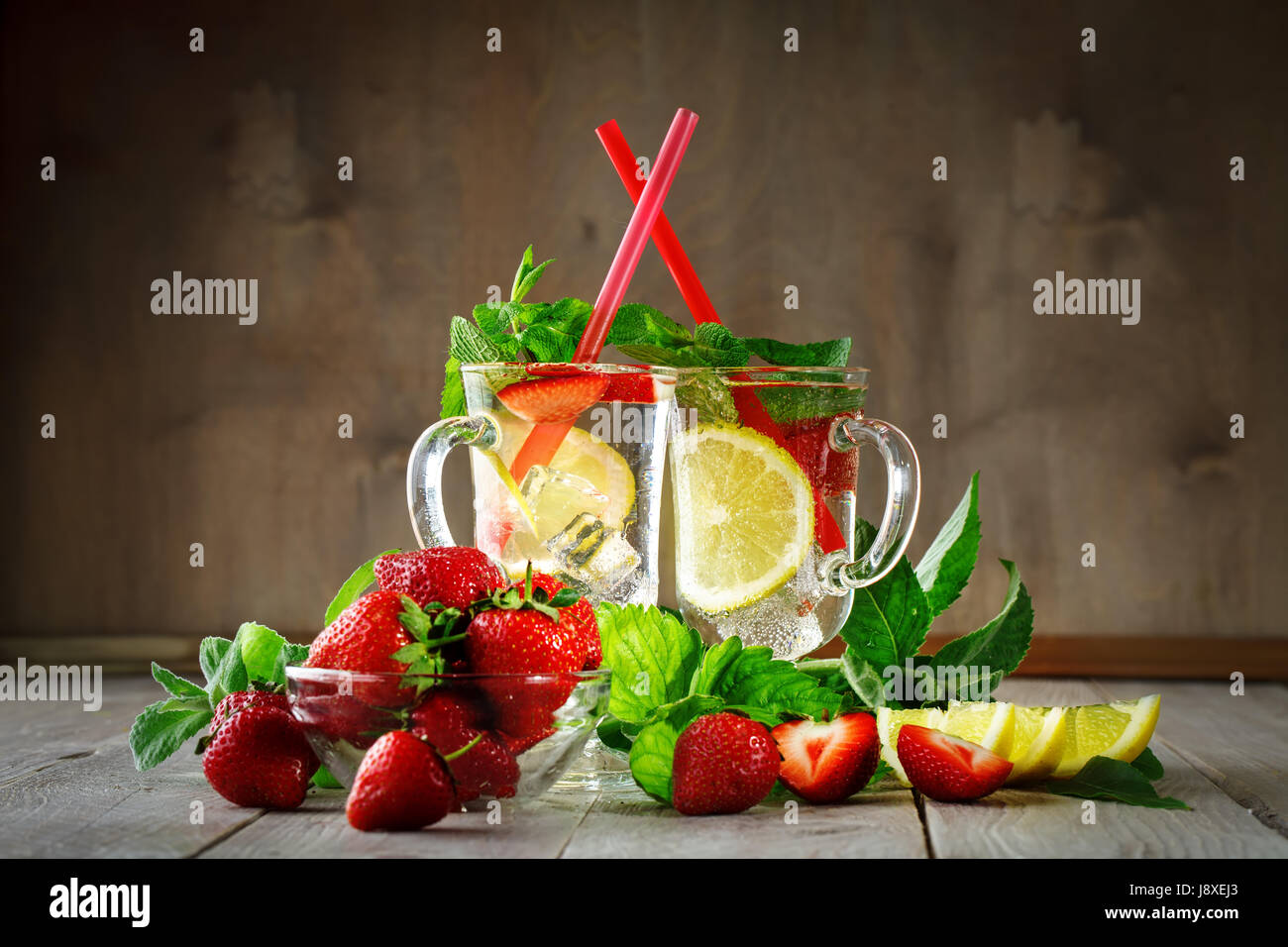 Fresh summer healthy drink with lemon and strawberries with ice. Stock Photo