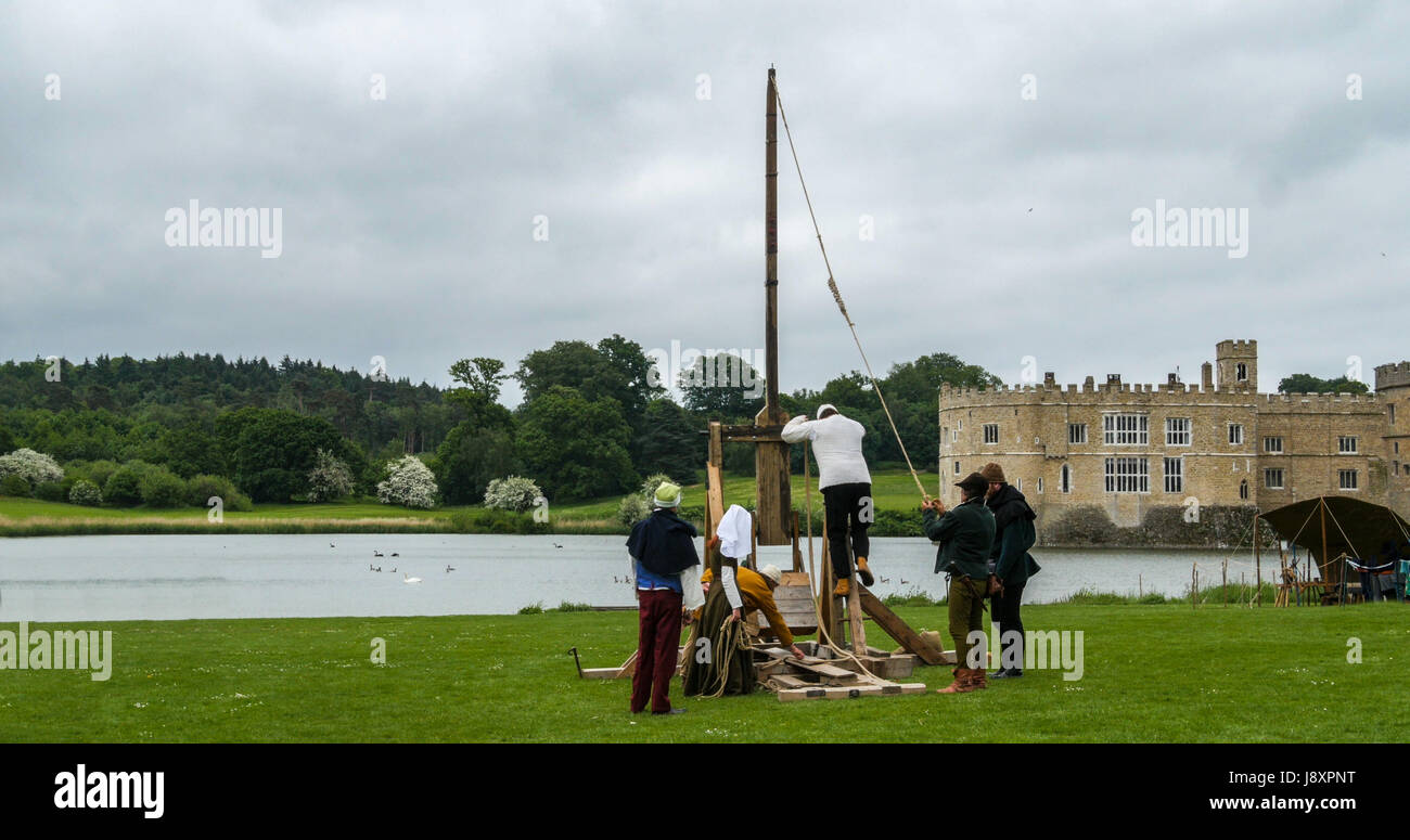 Loading a medieval trebouchet for shooting with medieval castle in the background Stock Photo