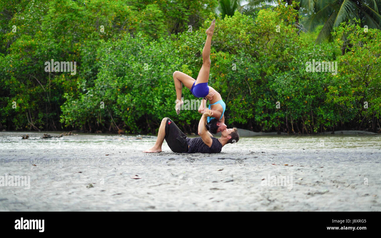 STUNNING photographs and video have revealed one couple’s incredible bond as they combine their passions for yoga and free running. The incredible pictures show the husband and wife team balancing on each other to pull some impressive shapes on the beach and in the park whilst video footage show the pair mastering a romantic backbend kiss. Other gravity defying shots show Amor Armitage balancing on a piece of driftwood whilst her husband, Chase performs an impressive flip through the air. @chaseyamor / mediadrumworld.com Stock Photo