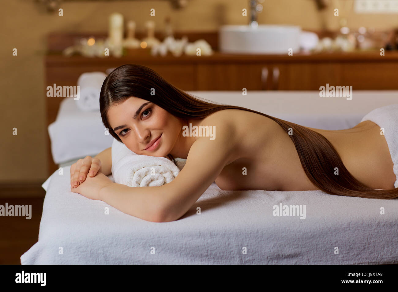Young woman lying in spa salon Stock Photo