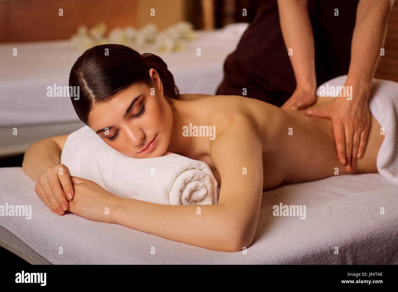 Beautiful woman lying in spa massage salon Stock Photo