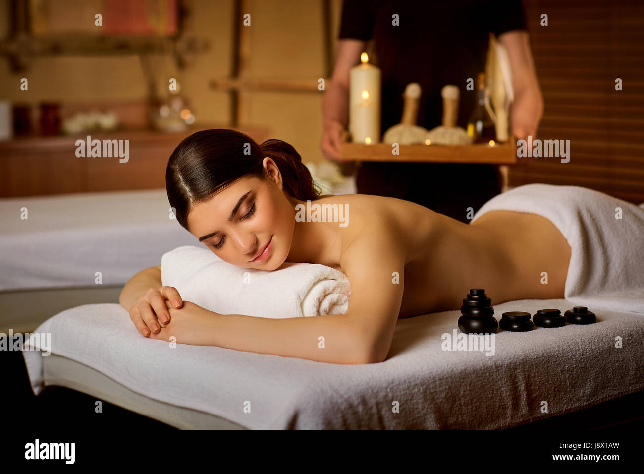 Beautiful woman lying in spa massage salon Stock Photo