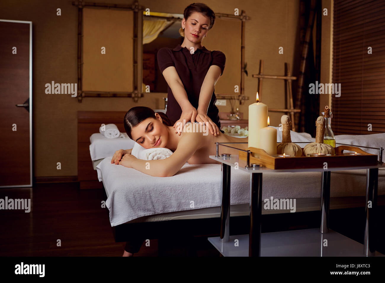 Relaxing massage for a woman in  spa salon Stock Photo