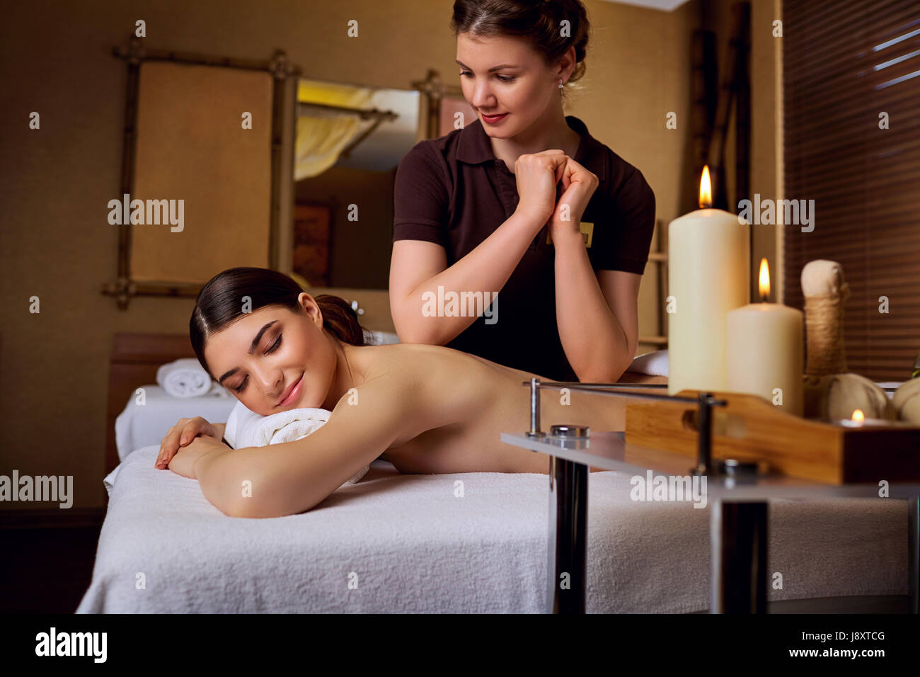 Masseur girl doing massage to woman in spa salon Stock Photo