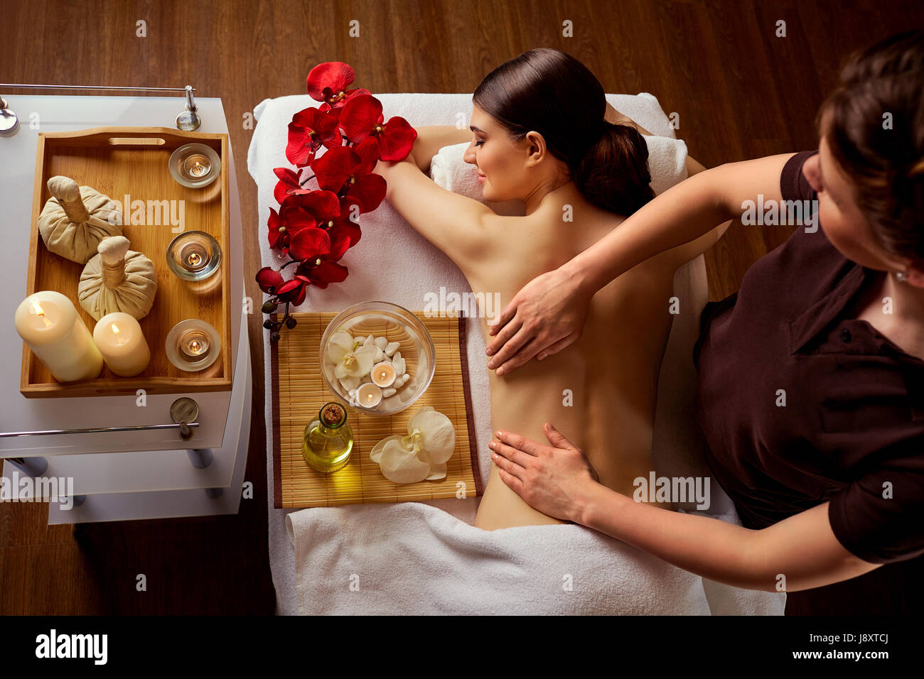 Young woman in spa massage salon. Top view Stock Photo