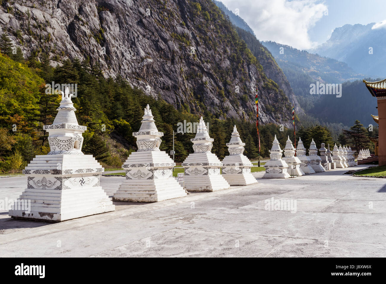 Tibetan stupa architecture (stupas) in a row, mountains background in Jiuzhai Valley, Sichuan province, China Stock Photo
