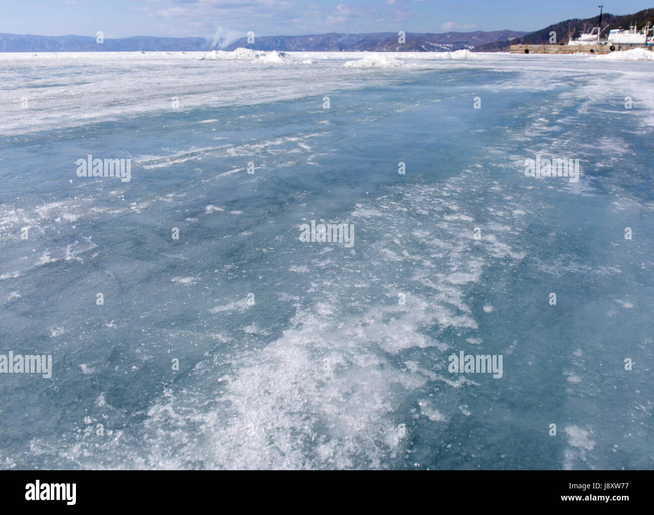 Baikal lake spring landscape view. Snow-covered surface of the ice lake. Winter. Stock Photo