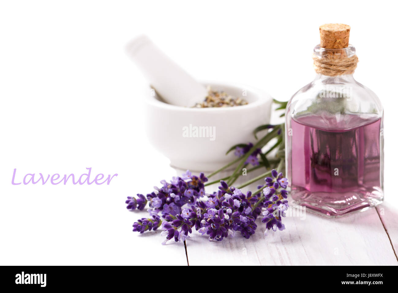 lavender flowers and essential oil over white background. Spa and ...