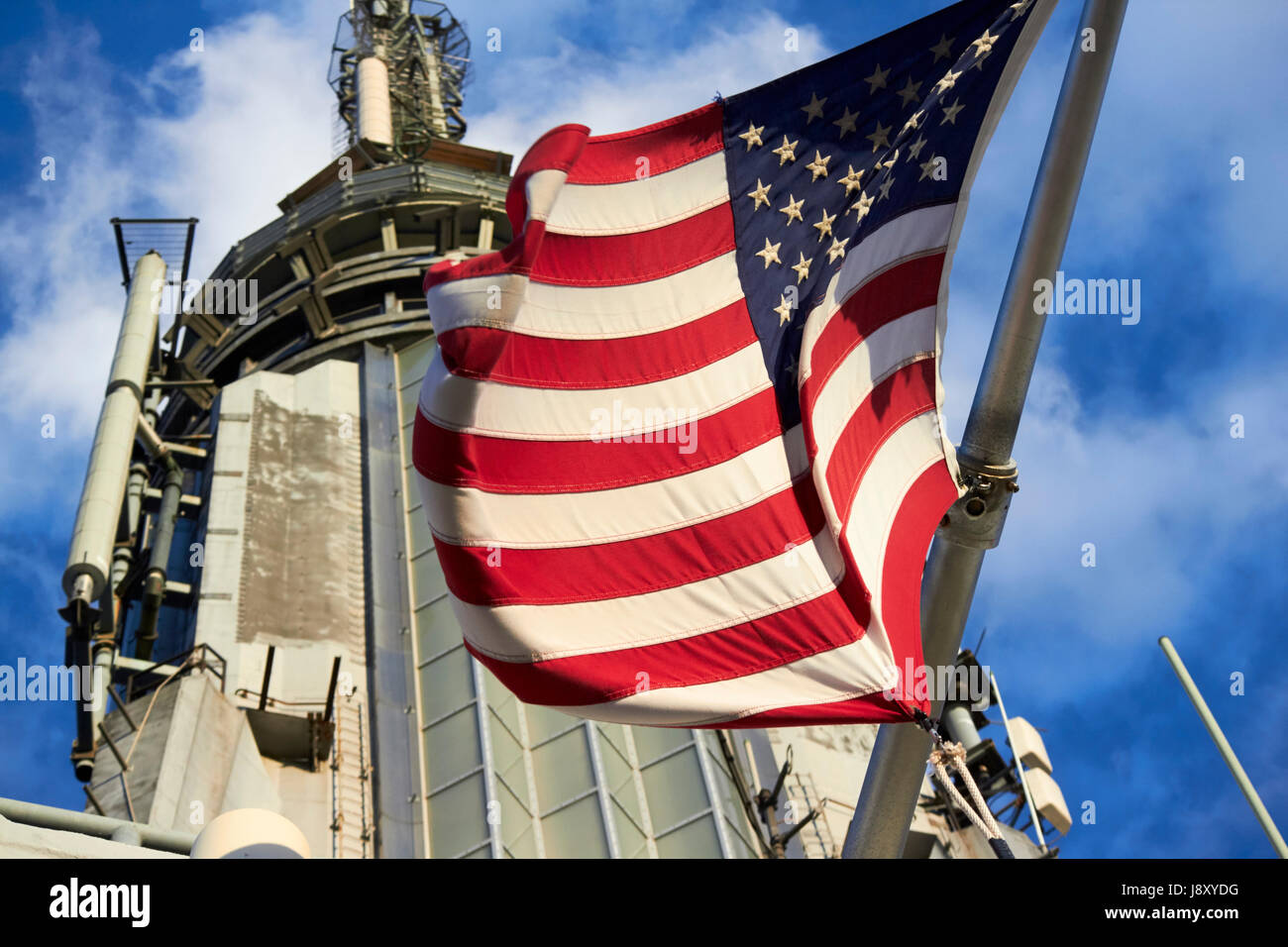 us flag flying at the top of the empire state building New York City USA Stock Photo