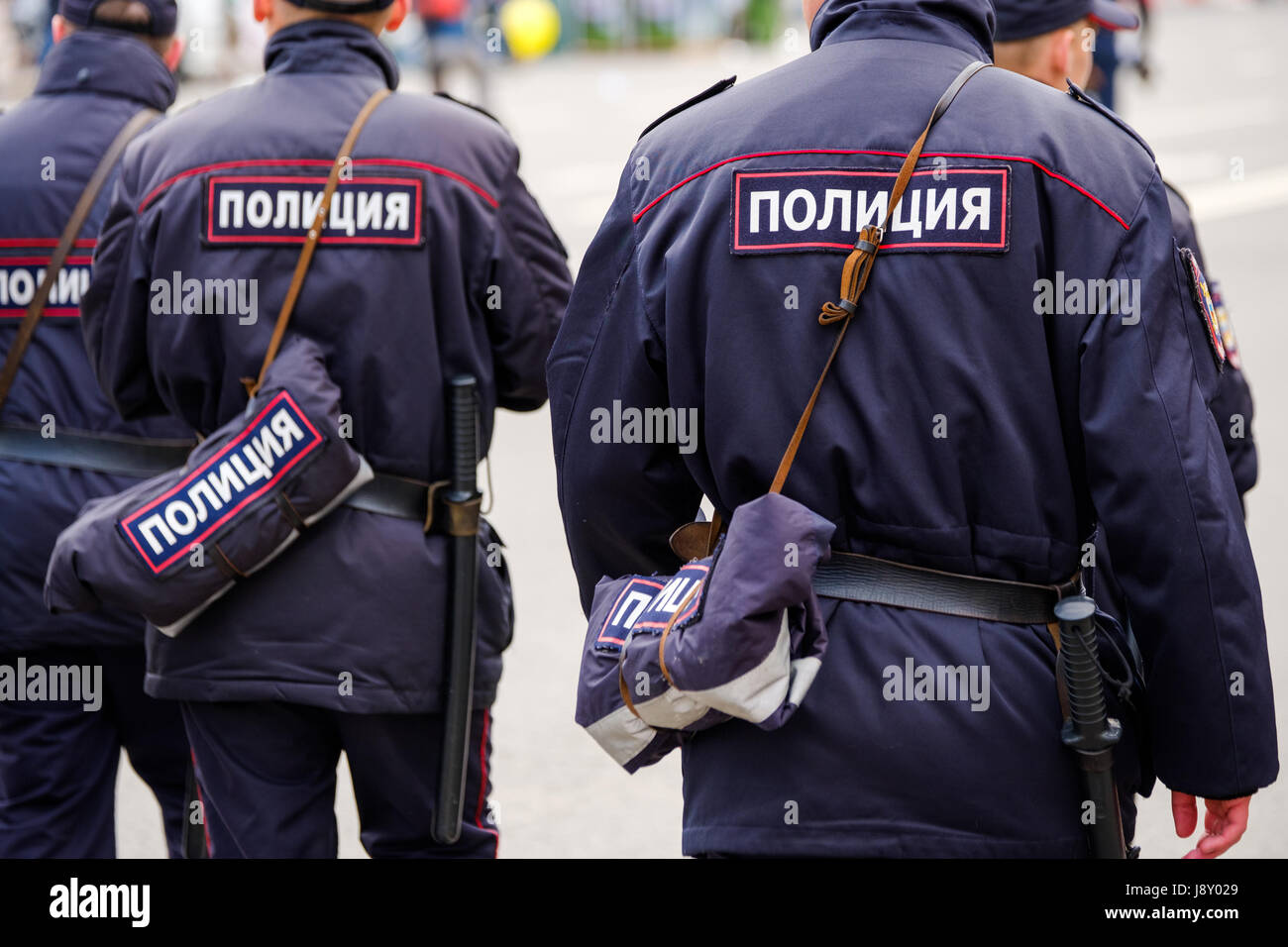 Policemen in uniform, rear view Stock Photo - Alamy