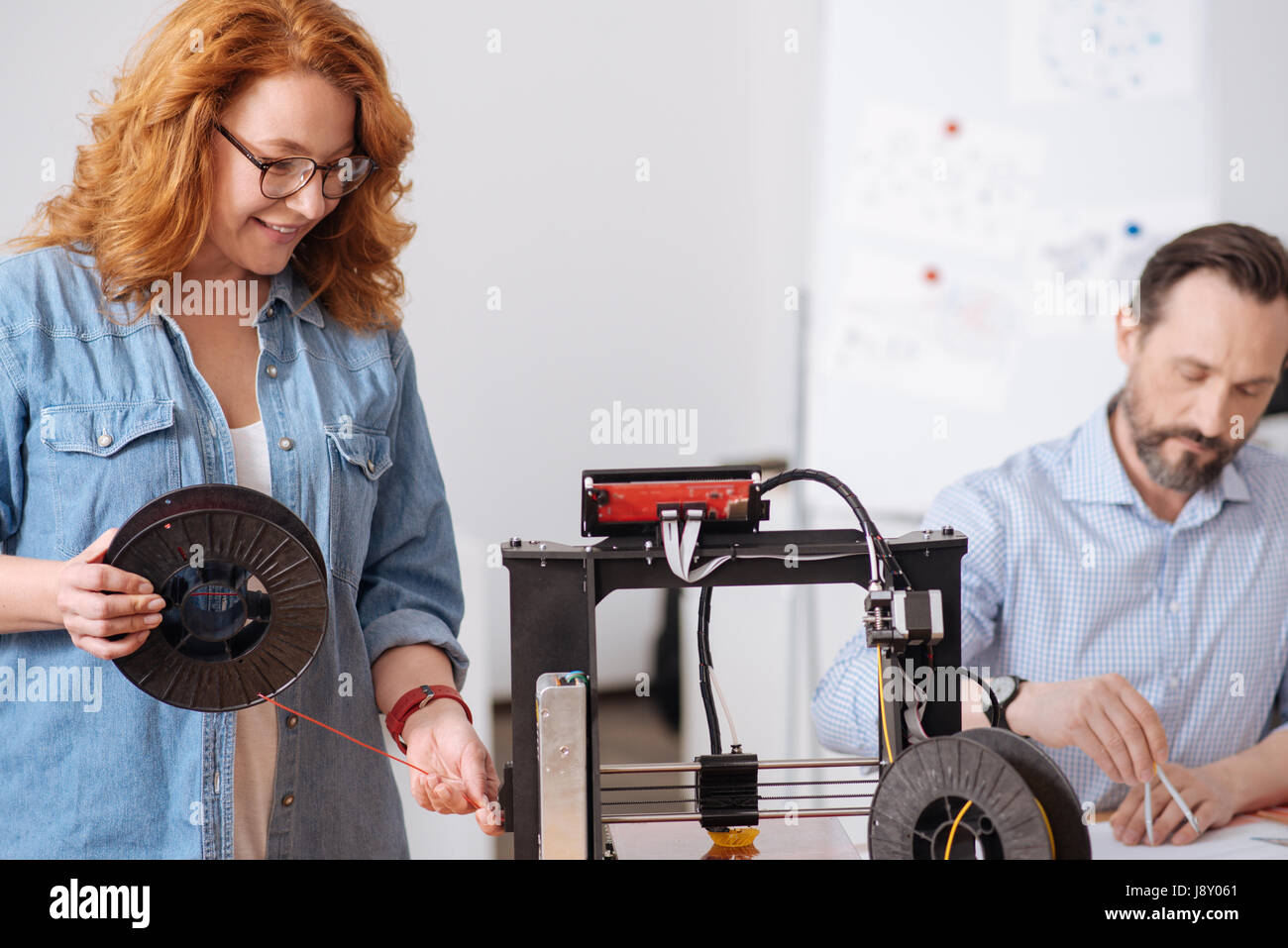 Nice delighted woman holding a filament coil Stock Photo