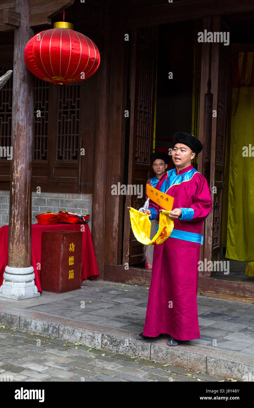 Guilin, China.  Oral History Performer Preparing to Announce Results of Examinations Given for Entry into Imperial Service. Stock Photo