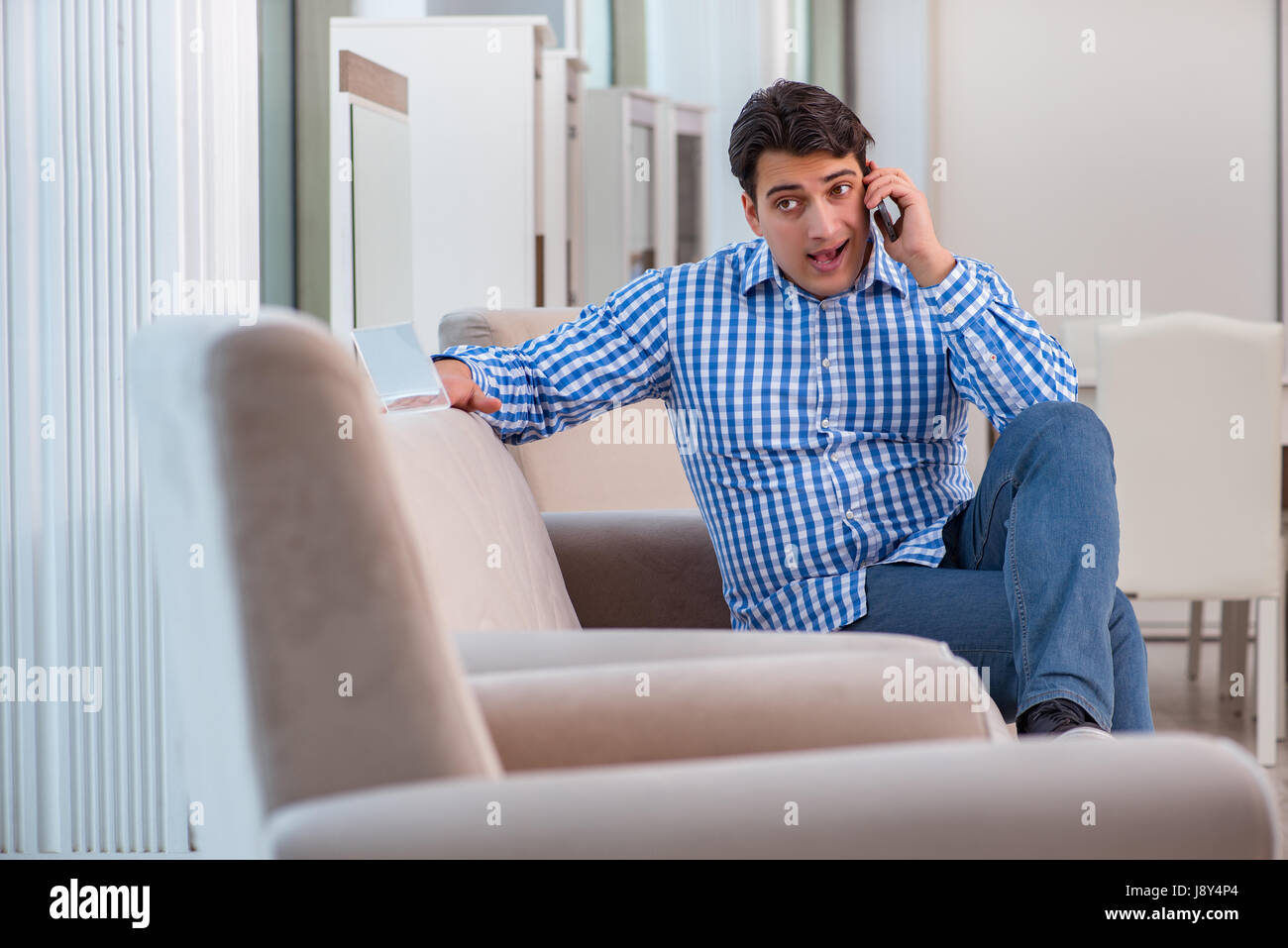 Young man shopping in furniture store Stock Photo - Alamy