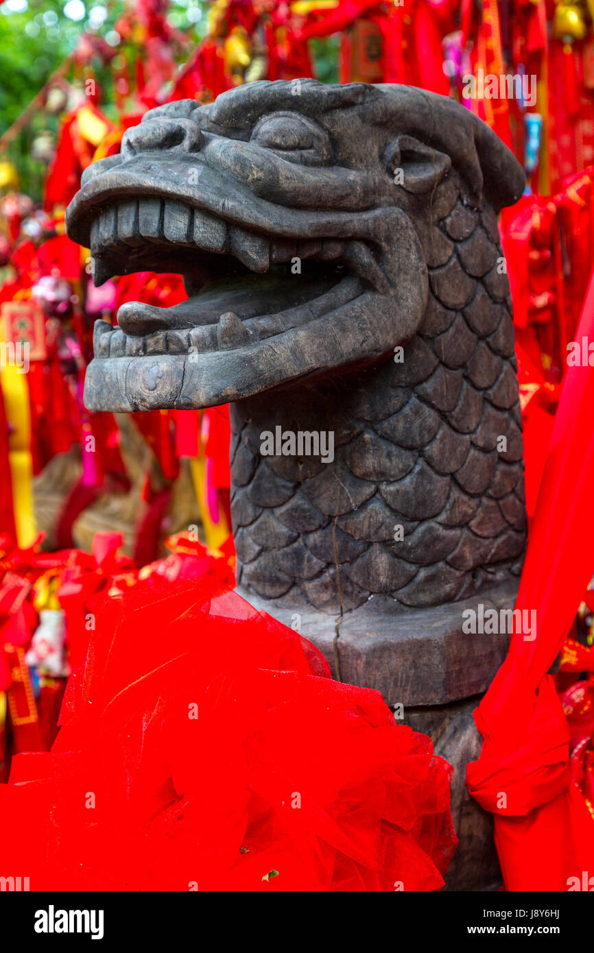 Guilin, China.  Elephant Trunk Hill Park.  Red Ribbons Requesting a Wish Surround Zodiac Sign under a Tree. Stock Photo