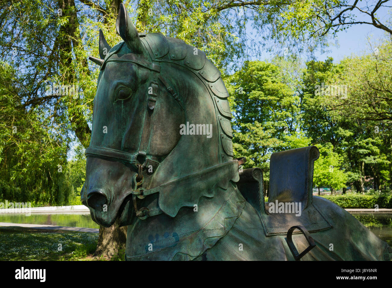 Dappled Spring sunlight on a bronze horse in Rowntree Park, City of York, UK Stock Photo