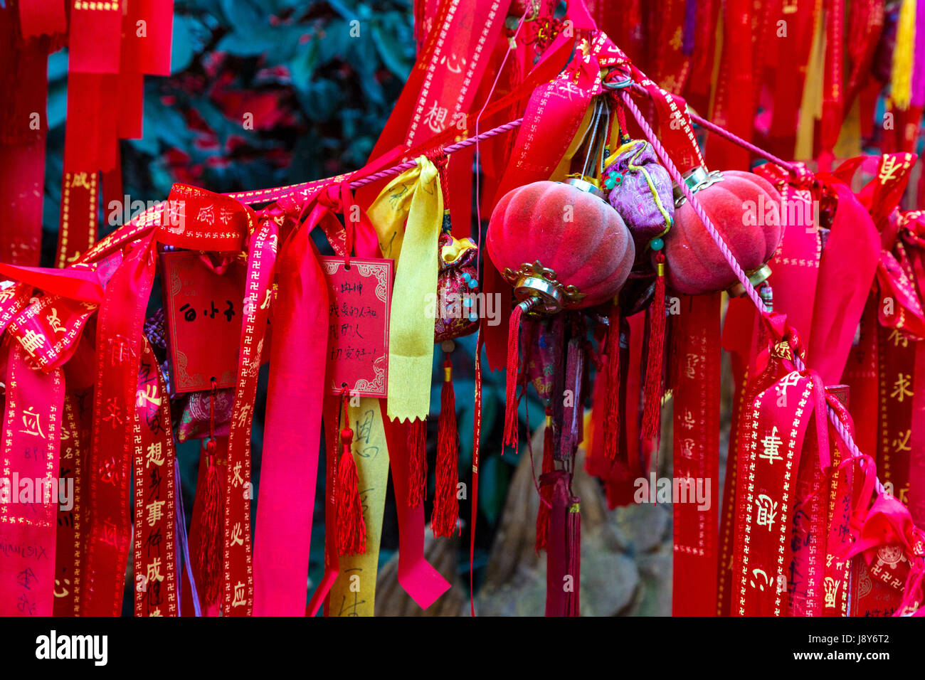 Guilin, China.  Elephant Trunk Hill Park.  Red Ribbons Hanging on a Tree, Requesting a Wish for the New Year. Stock Photo