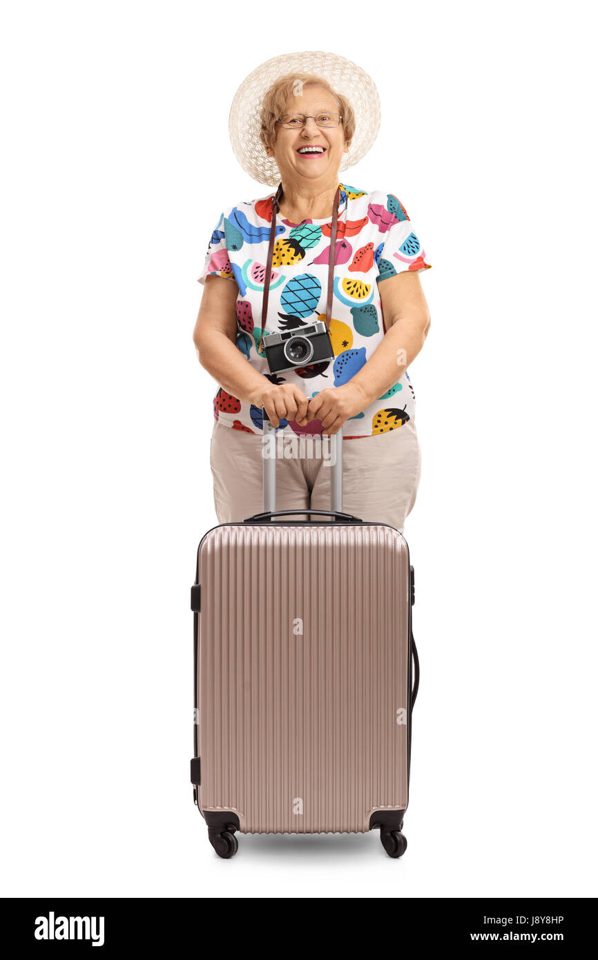 Elderly tourist with a suitcase looking at the camera and smiling isolated on white background Stock Photo