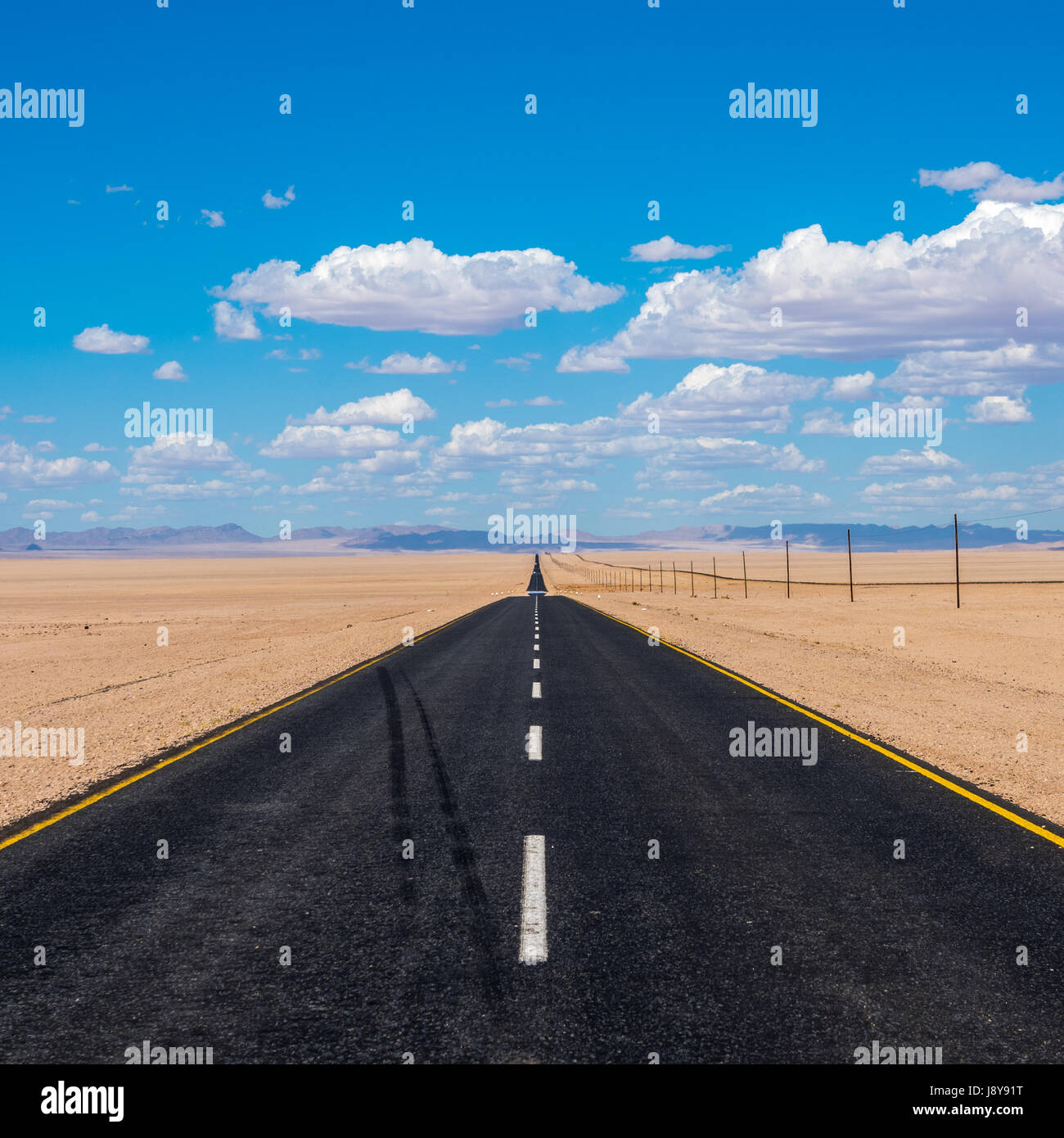 vibrant image of highway and blue cloudy sky Stock Photo - Alamy