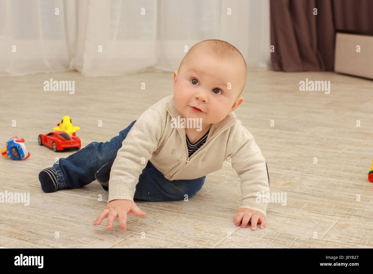 cute baby boy playing with toys in living room Stock Photo - Alamy