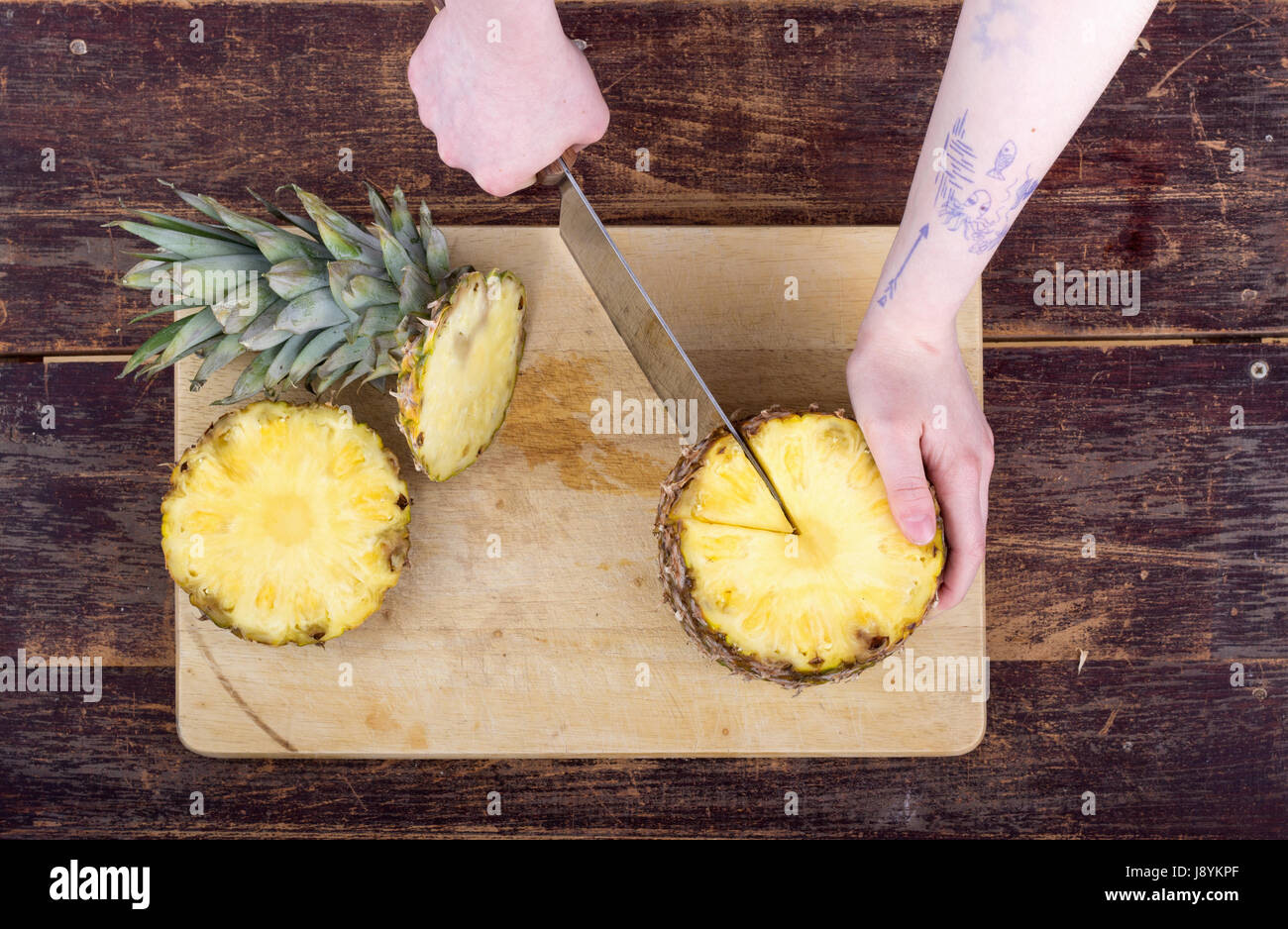 A girl is cutting a pineapple Stock Photo Alamy