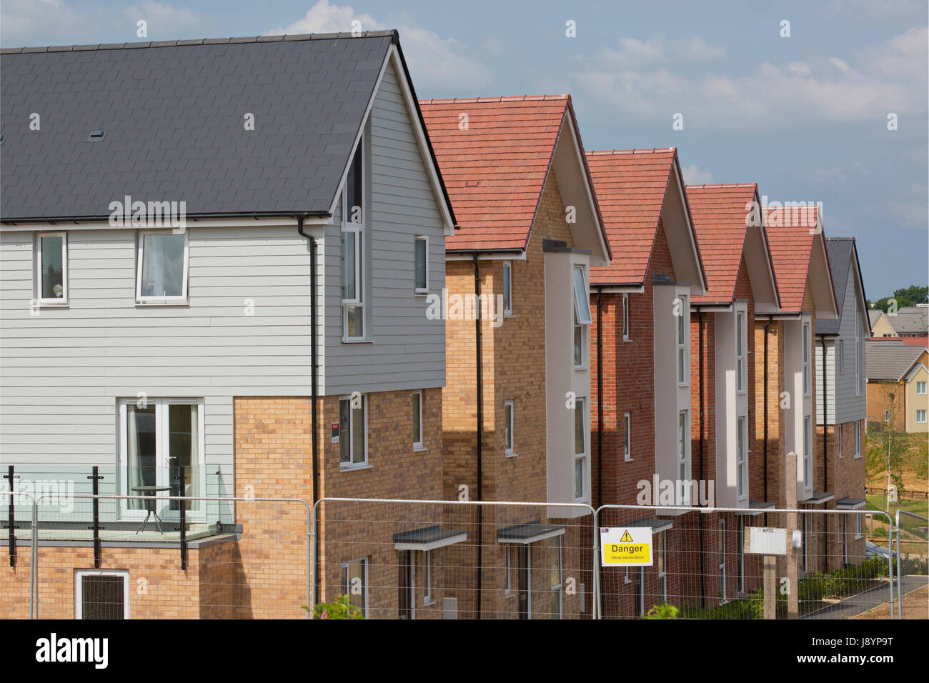 A row of new houses on a large development nearing completion Stock Photo