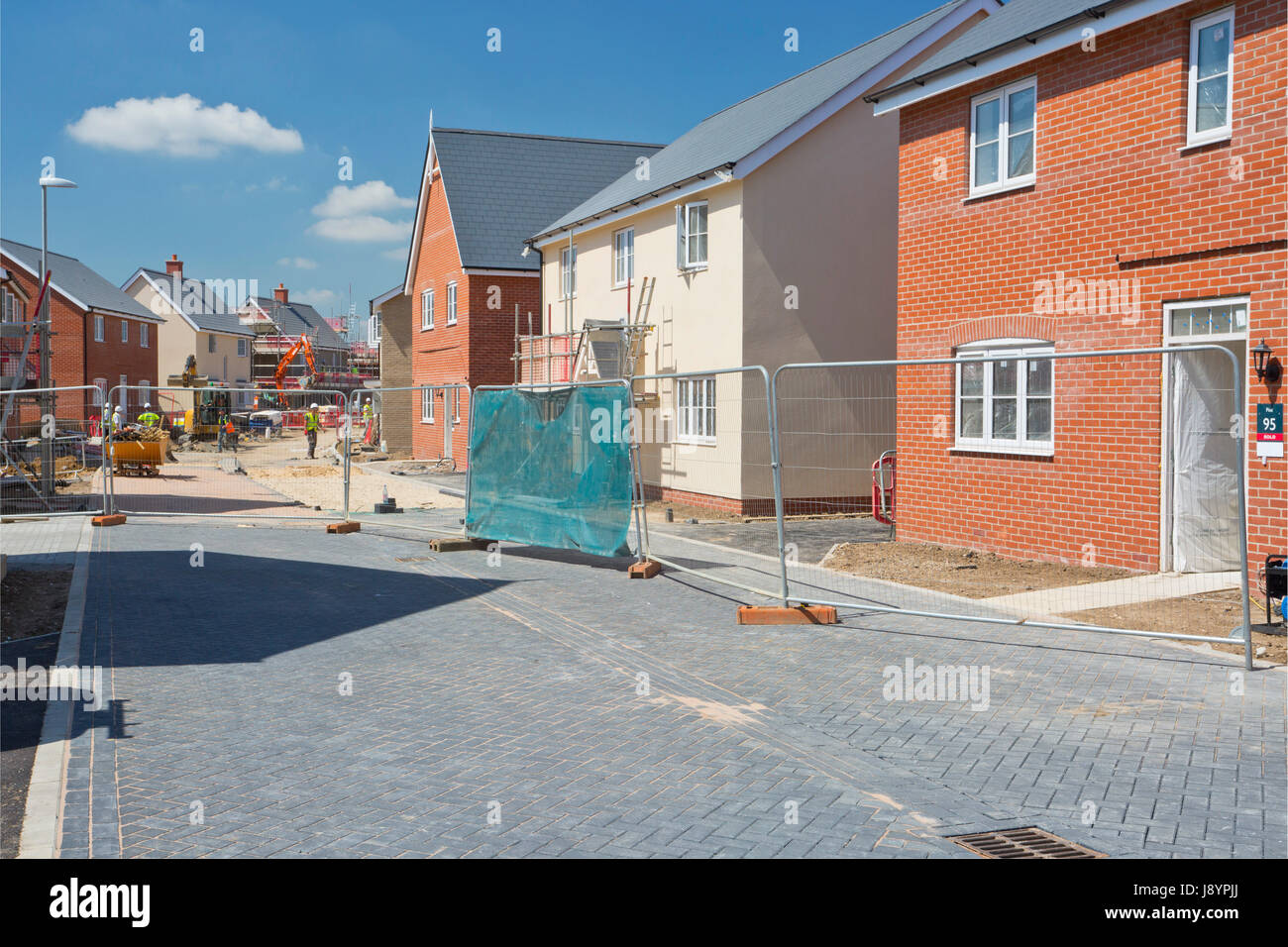 A building site on a large new greenfield housing development with breeze blocks, half built walls, bricks and scaffolding Stock Photo