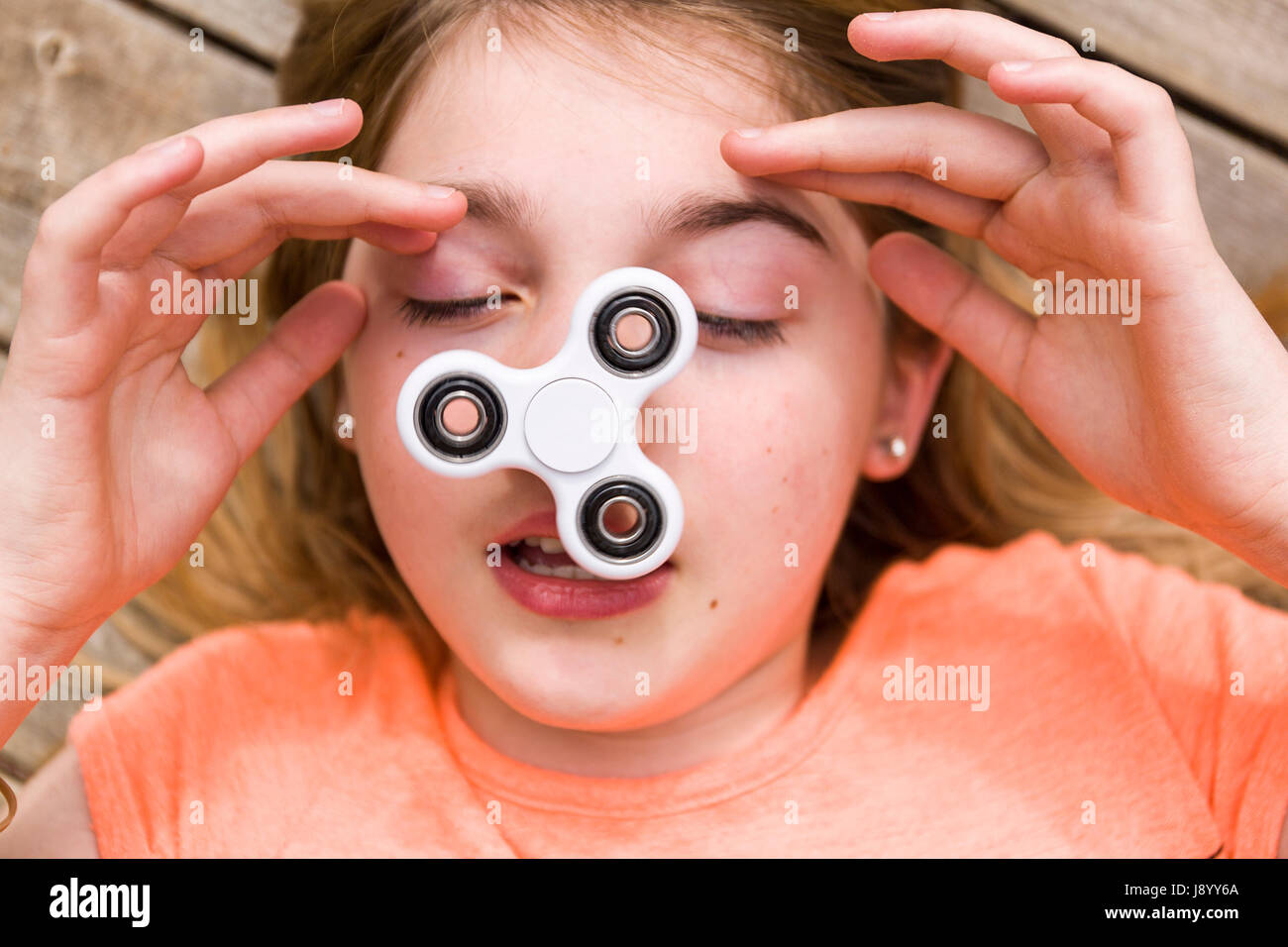 Girl with spinning fidget spinner hi-res stock photography and images -  Alamy