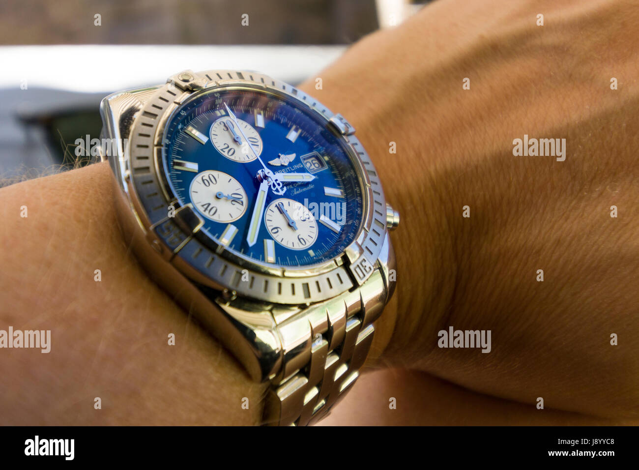 Luxury Breitling Chronomat Evolution watch with blue face on man's wrist  Model Release: Yes. Property release: No Stock Photo - Alamy