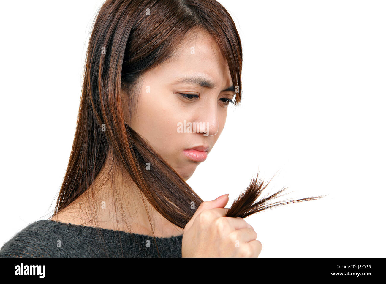 Portrait of beautiful young woman combing her hair and smiling Stock Photo....