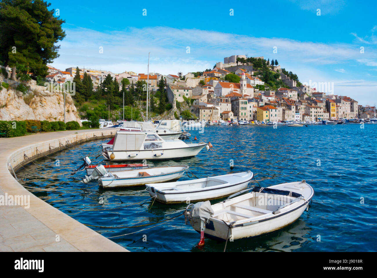 Boats on seaside promenade, with old town in background, Sibenik, Dalmatia, Croatia Stock Photo