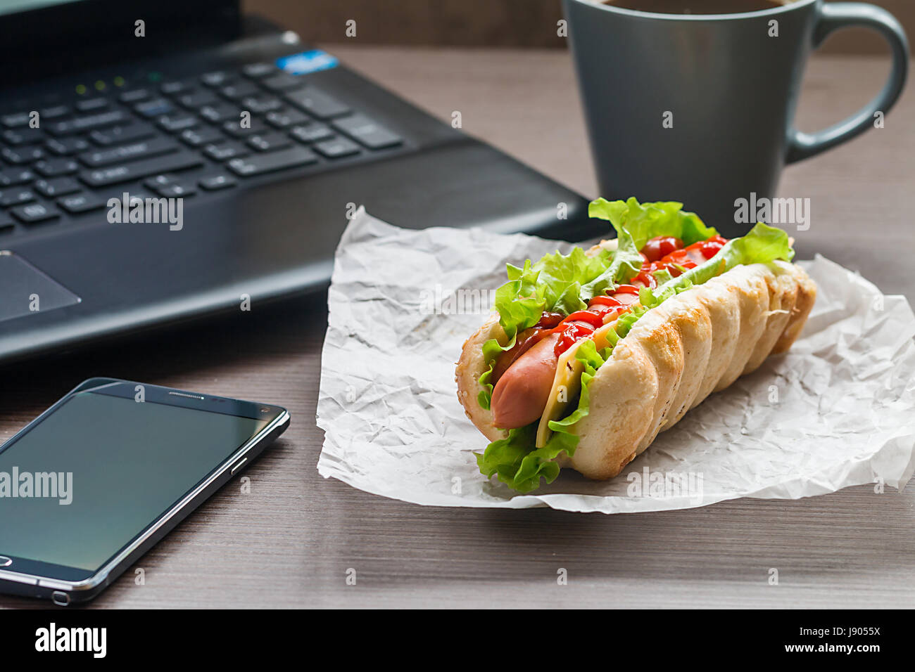 quick lunch of hotdog in the office near the laptop Stock Photo Alamy