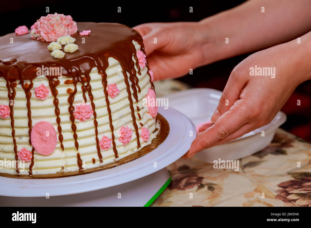 covering a cake with chocolate icing sponge cake covered in chocolate