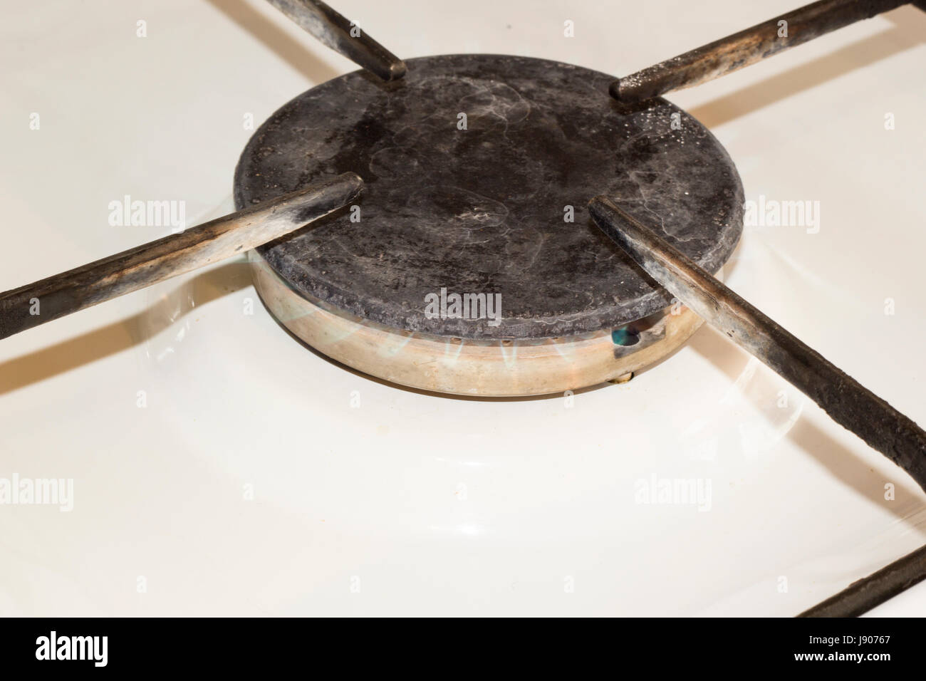 The gas burner burns with a small blue flame Stock Photo Alamy