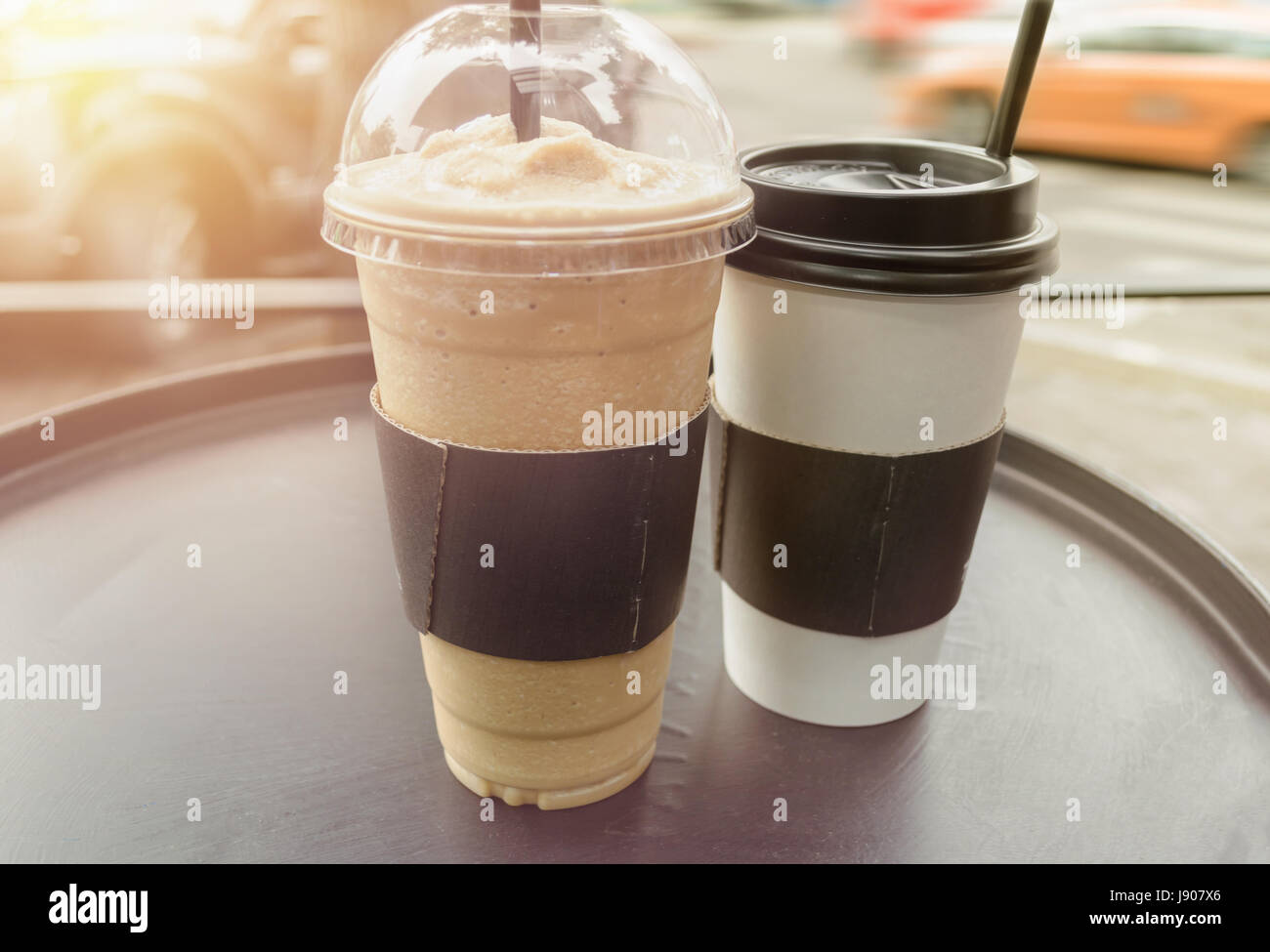 couple of frappe and coffee mugs on black round table Stock Photo Alamy