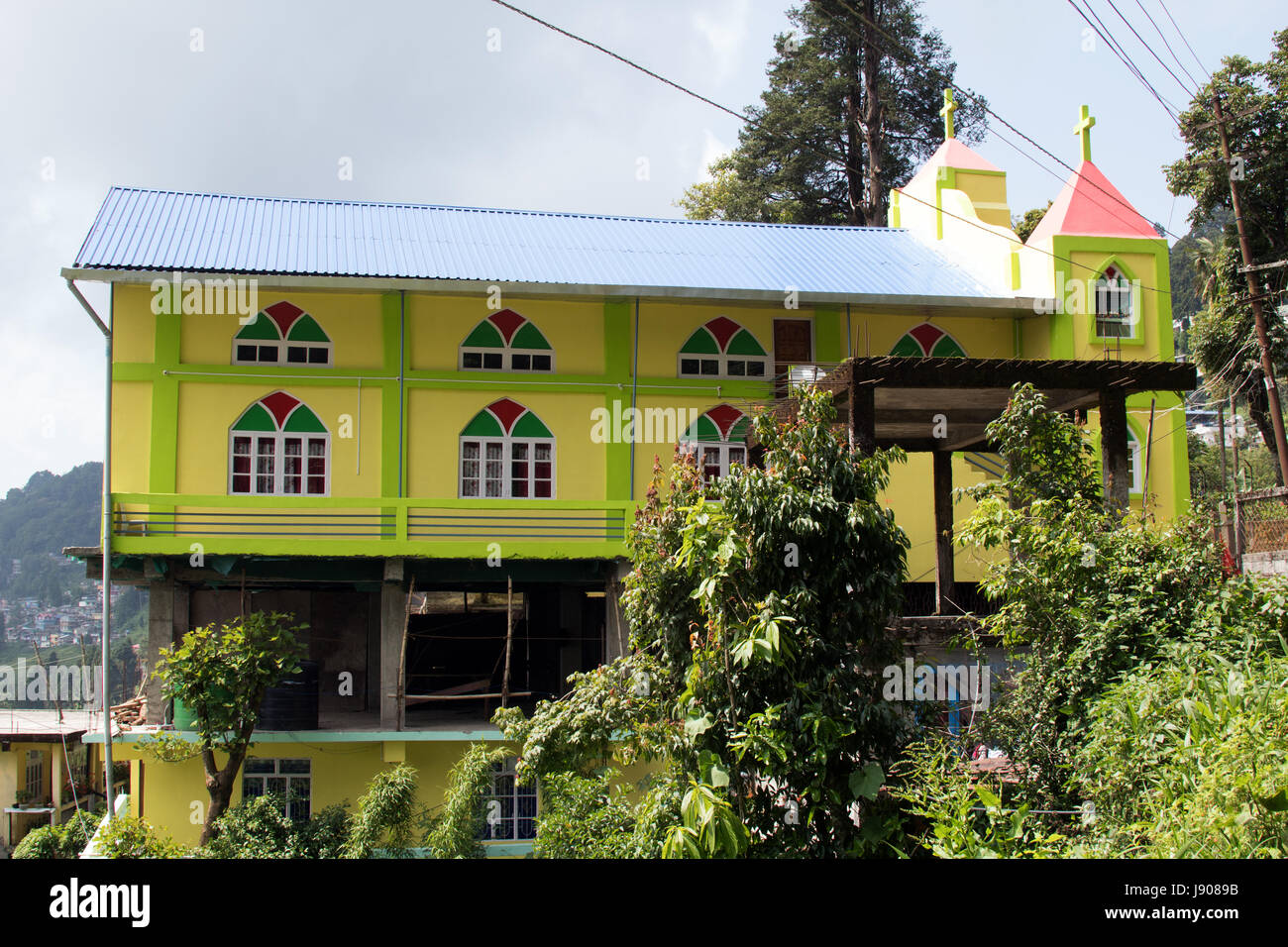 Newly built lime green painted church outside Lloyds Botanic Gardens Darjeeling West Bengal India Stock Photo