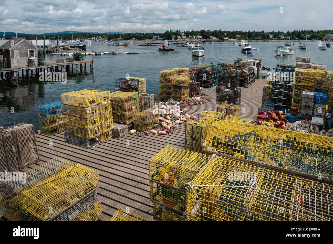 Lobster Traps on a Fishing Dock in Maine Stacks of lobster pots cover