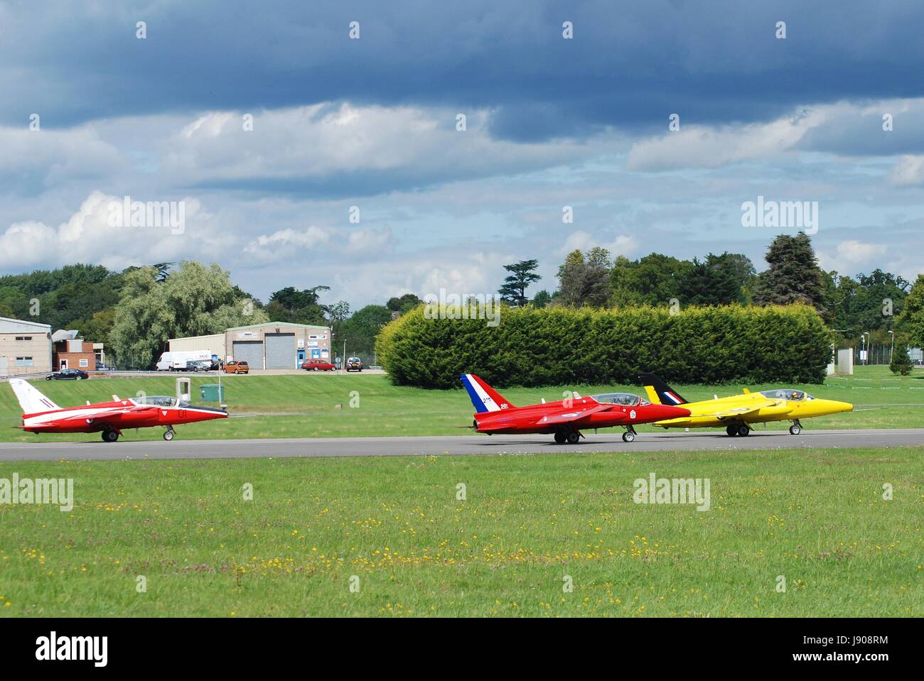 Folland Gnat T Mark 1 XR991 (yellow), XS111 (mid), XR538 (rear) taking off during the Dunsfold airshow at Surrey, England on August 23, 2014. Stock Photo