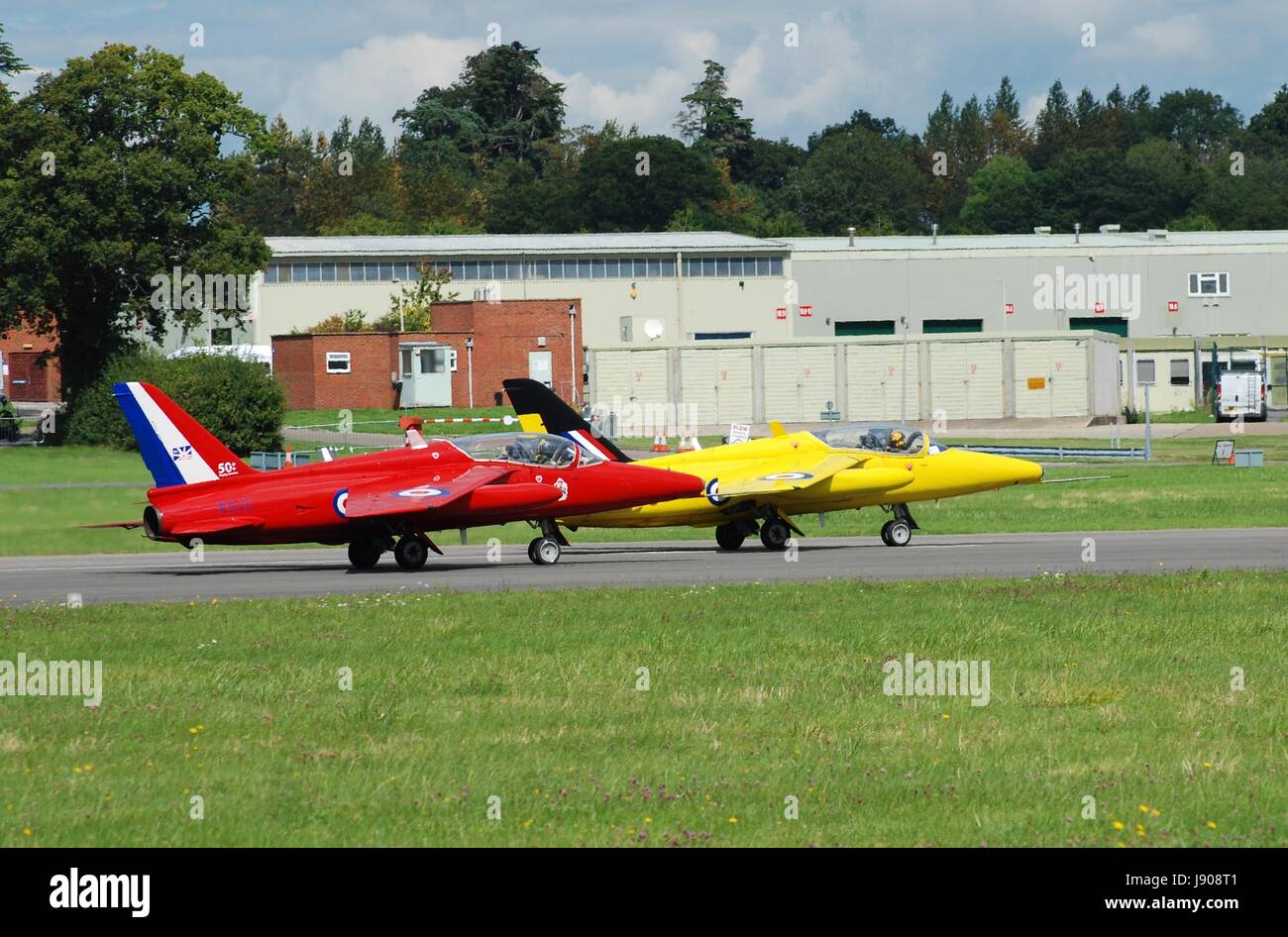 Folland Gnat T Mark 1 XR991 (yellow) and XS111 taking off at the Dunsfold airshow in Surrey, England on August 23, 2014. Stock Photo