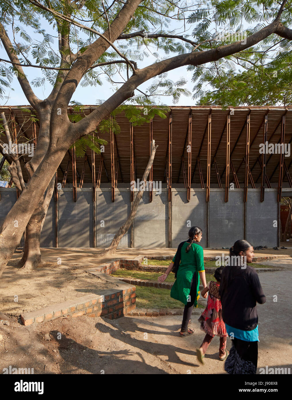 Locals approach centre at dawn. Jetvanaa, Sakharwadi, India. Architect: SP+a , 2016. Stock Photo
