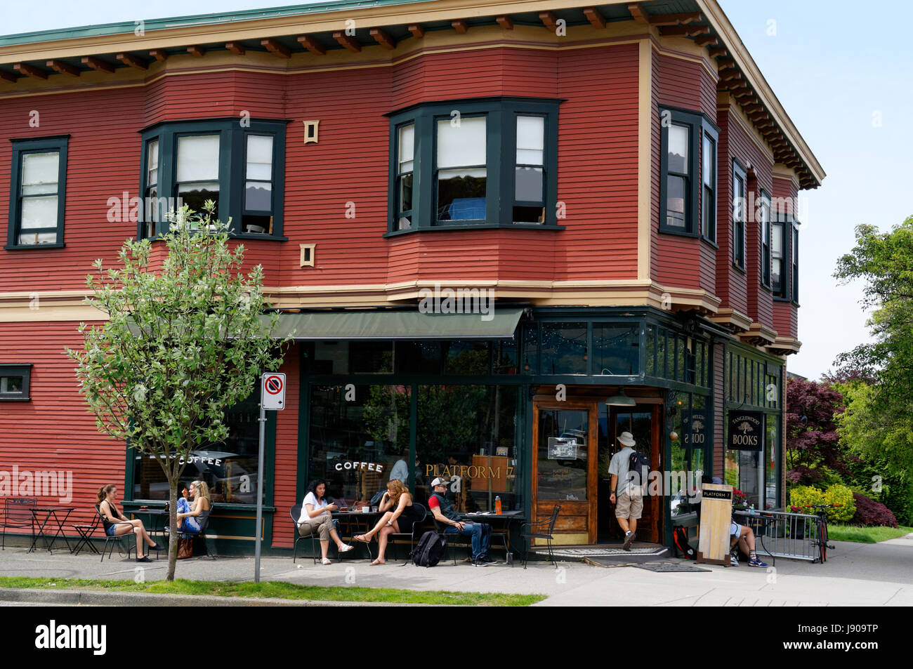 People relaxing outside Platform 7 Cafe coffee shop on West Broadway