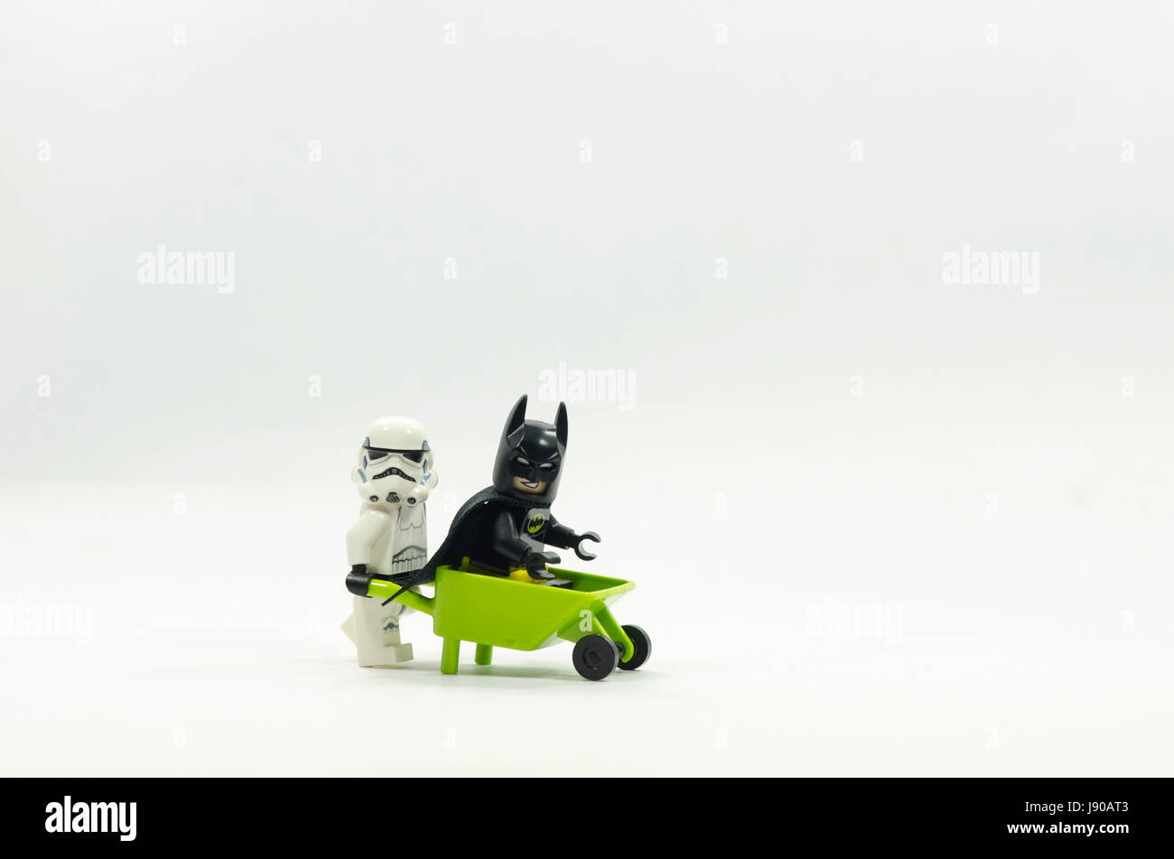 lego batman sitting on wheelbarrow and storm trooper pushing the  wheelbarrow Stock Photo - Alamy