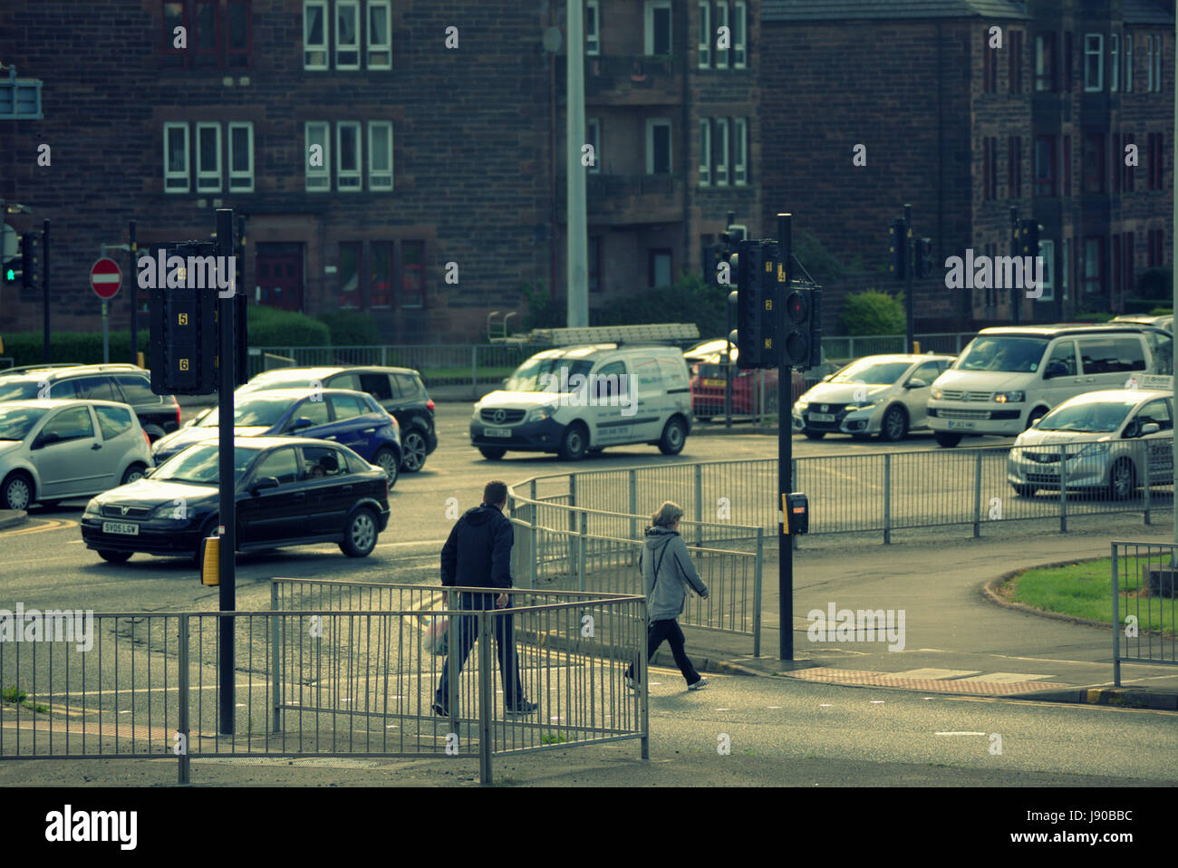 Anniesland cross Glasgow people crossing road at traffic lights at one of the busiest intersects in Europe Stock Photo