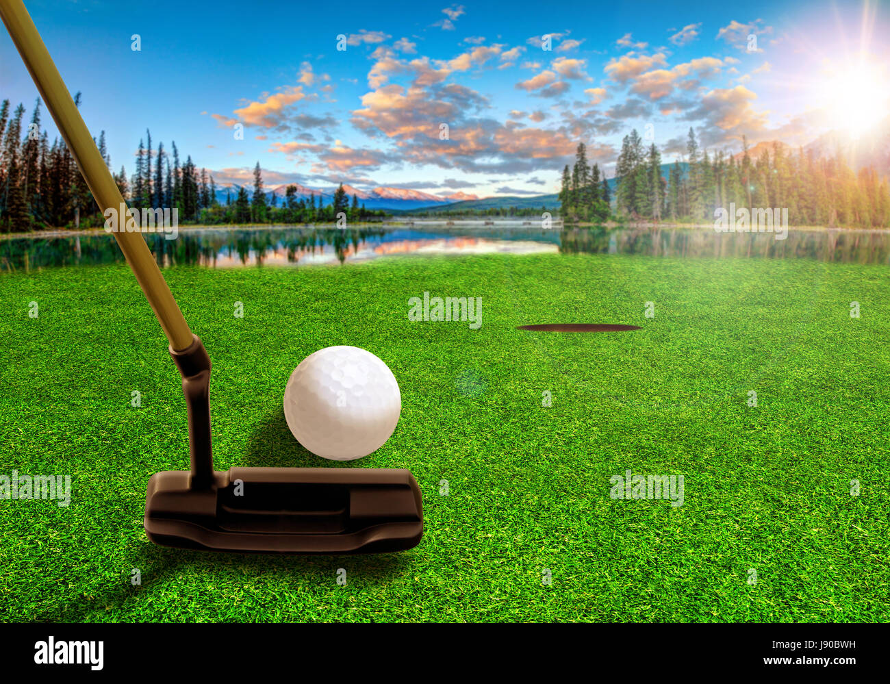 Golfer using a putter club to hit a golf ball on a beautiful golf