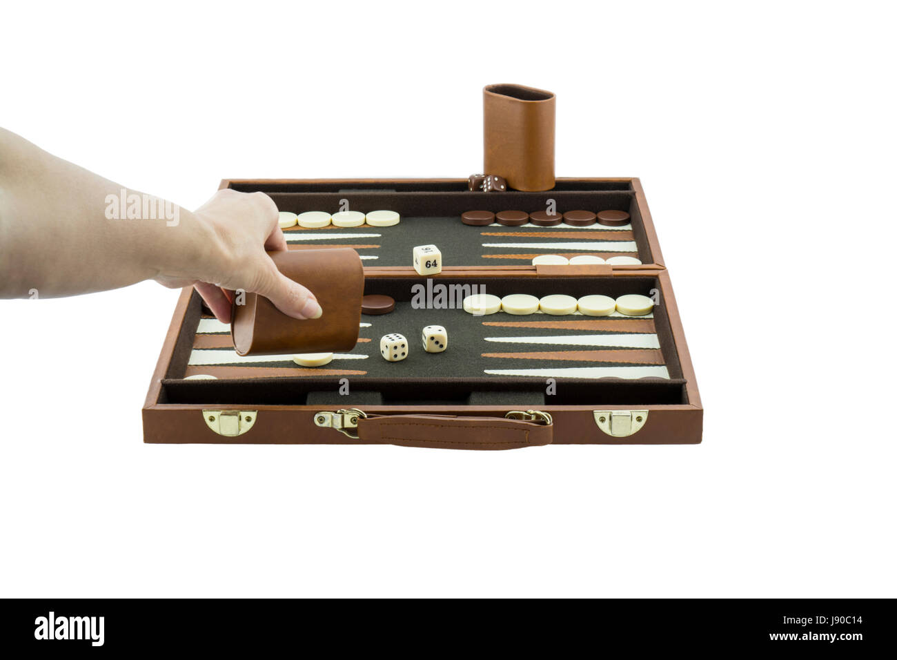 A woman's arm playing backgammon by throwing the die on the backgammon board with her left hand. Isolated on a pure white background. Stock Photo