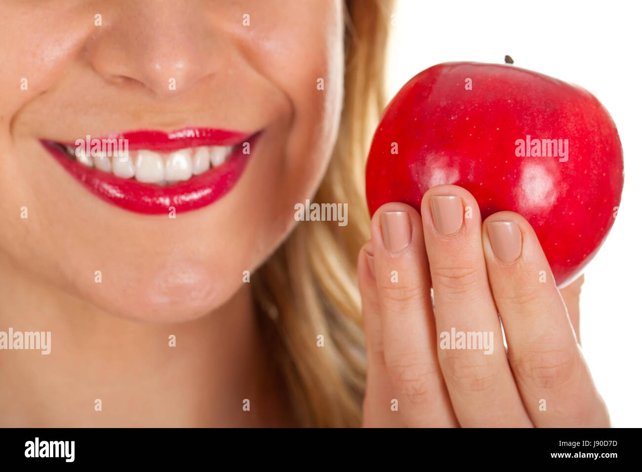Close up picture of a beautiful woman's red lips and a fresh red apple Stock Photo