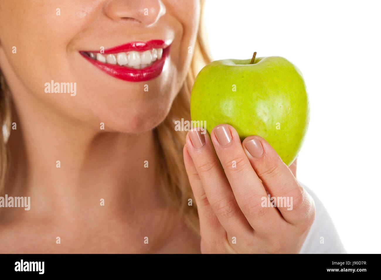 Close up picture of a beautiful woman's red lips and a fresh green apple Stock Photo